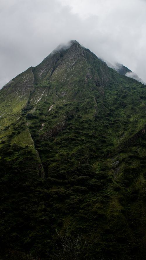 Free A dramatic shot of a misty mountain peak under overcast skies, capturing nature's majesty. Stock Photo
