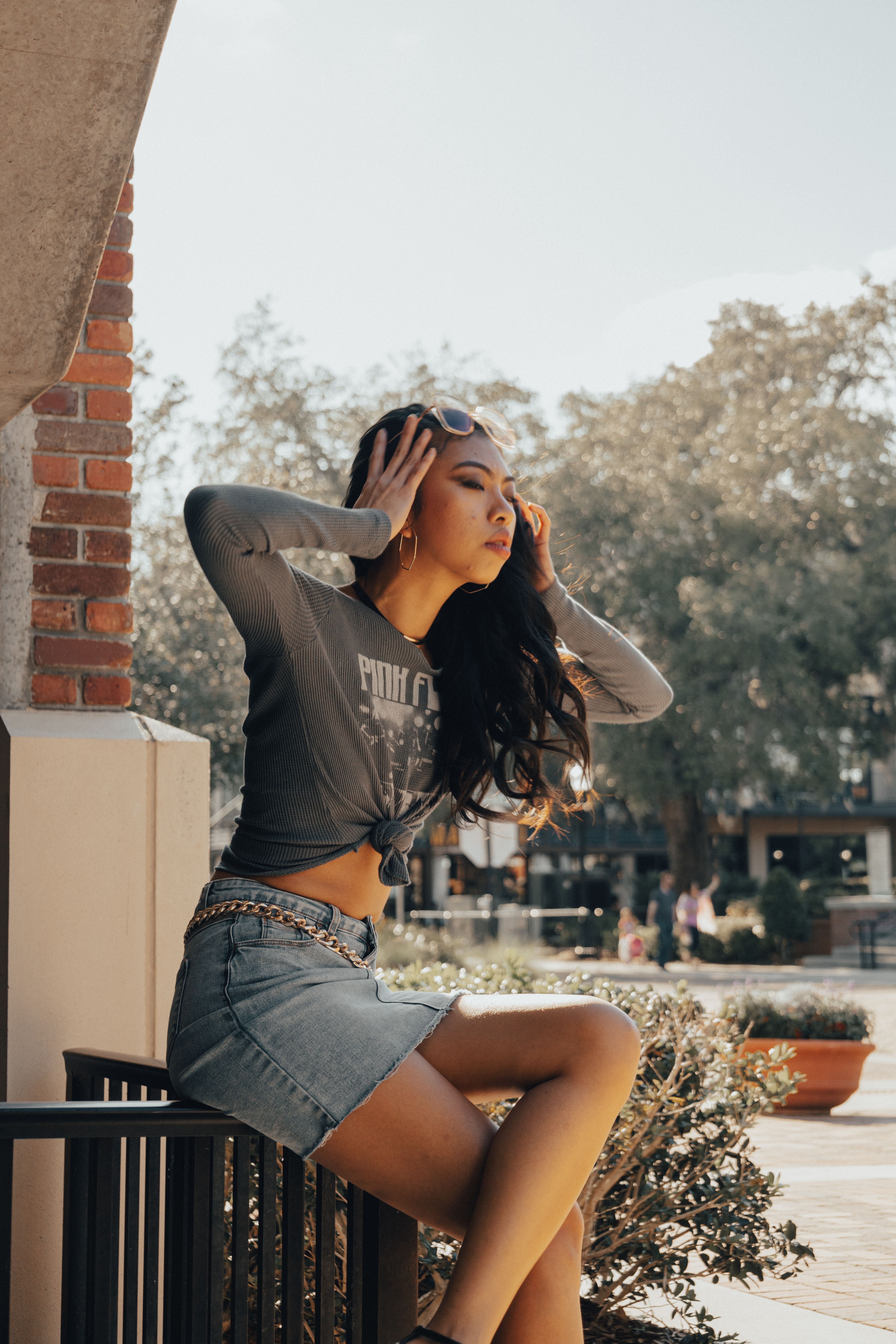 A woman in a denim skirt and a crop top · Free Stock Photo