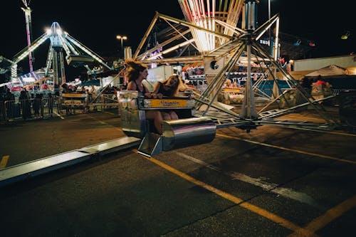 People on Carousel at Night