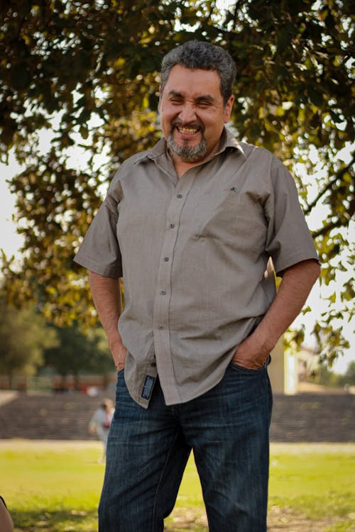 Smiling Man in Shirt Standing with Hands in Pockets