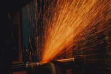 Orange sparks flying from an angle grinder, photo by Yassir Abbas on Pexels