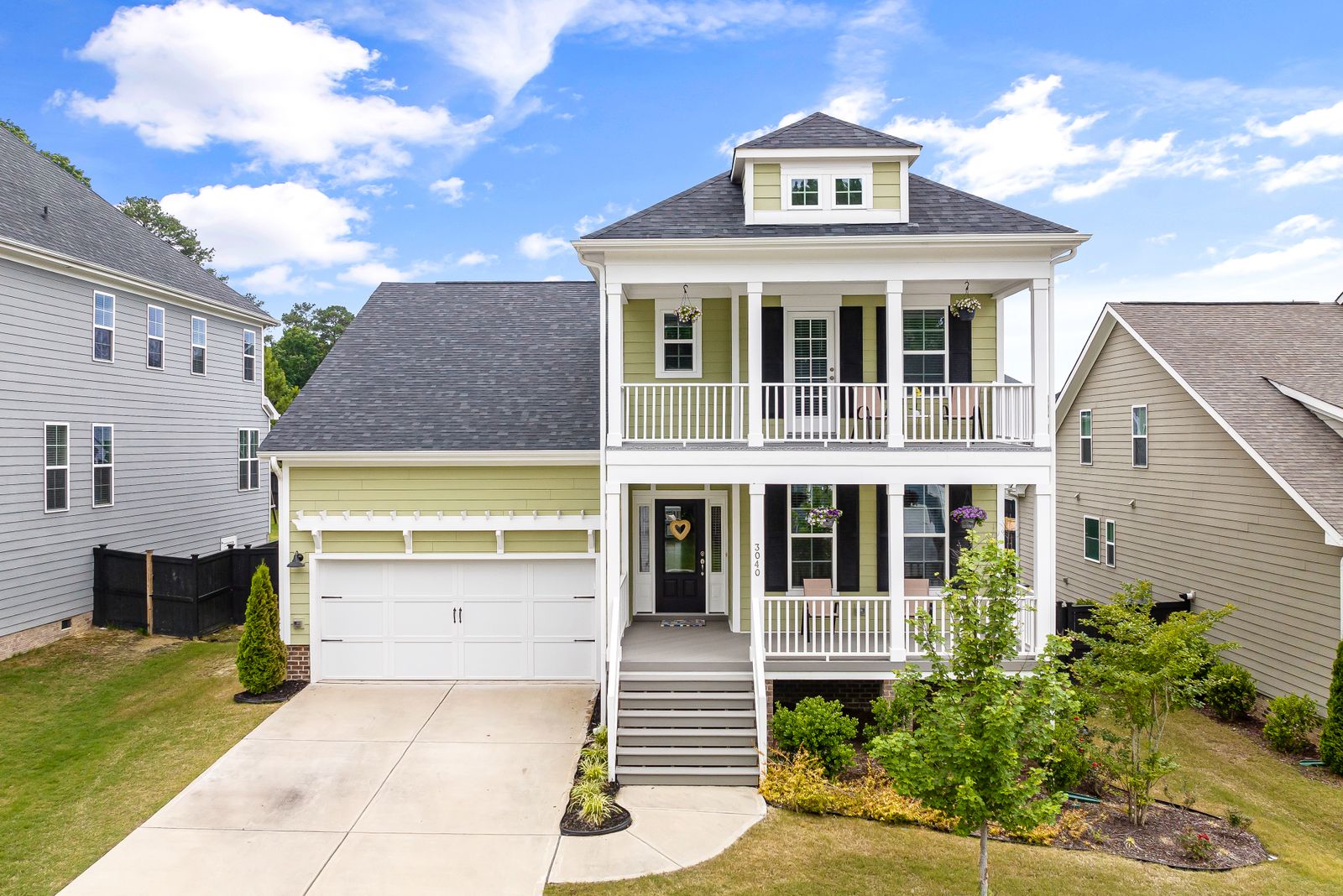 Concrete driveway at two-story porch home