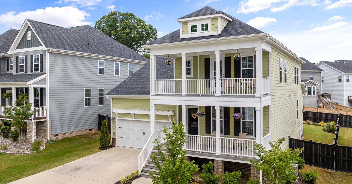 Aerial view of modern suburban homes with balconies in Wake Forest, NC, on a sunny day.