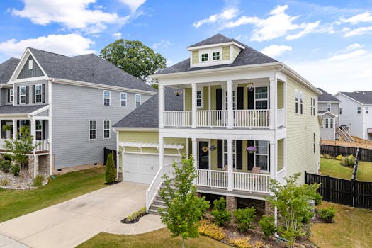 Aerial view of modern suburban homes with balconies in Wake Forest, NC, on a sunny day.