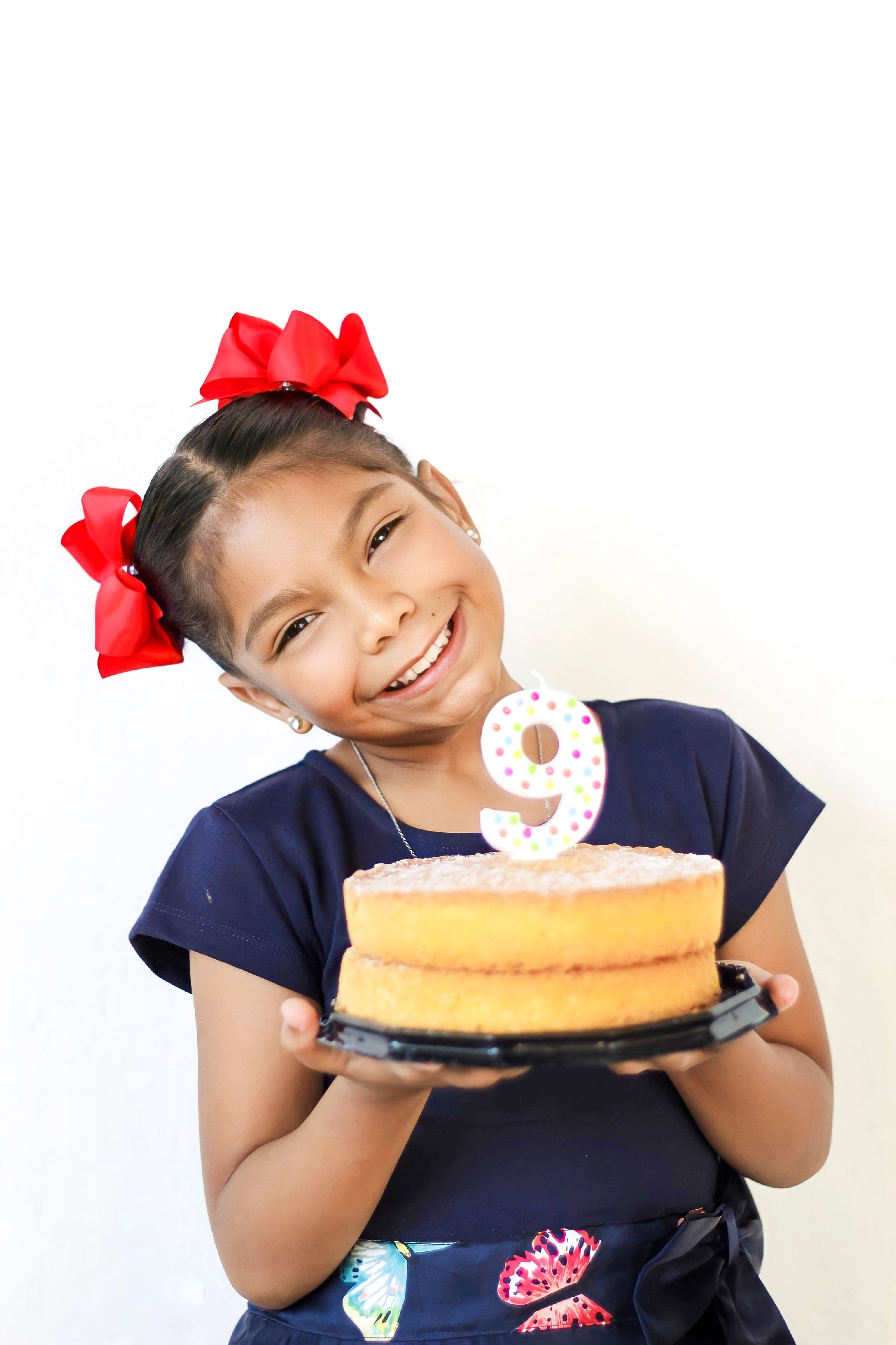 Smiling Girl Holding a Birthday Cake · Free Stock Photo