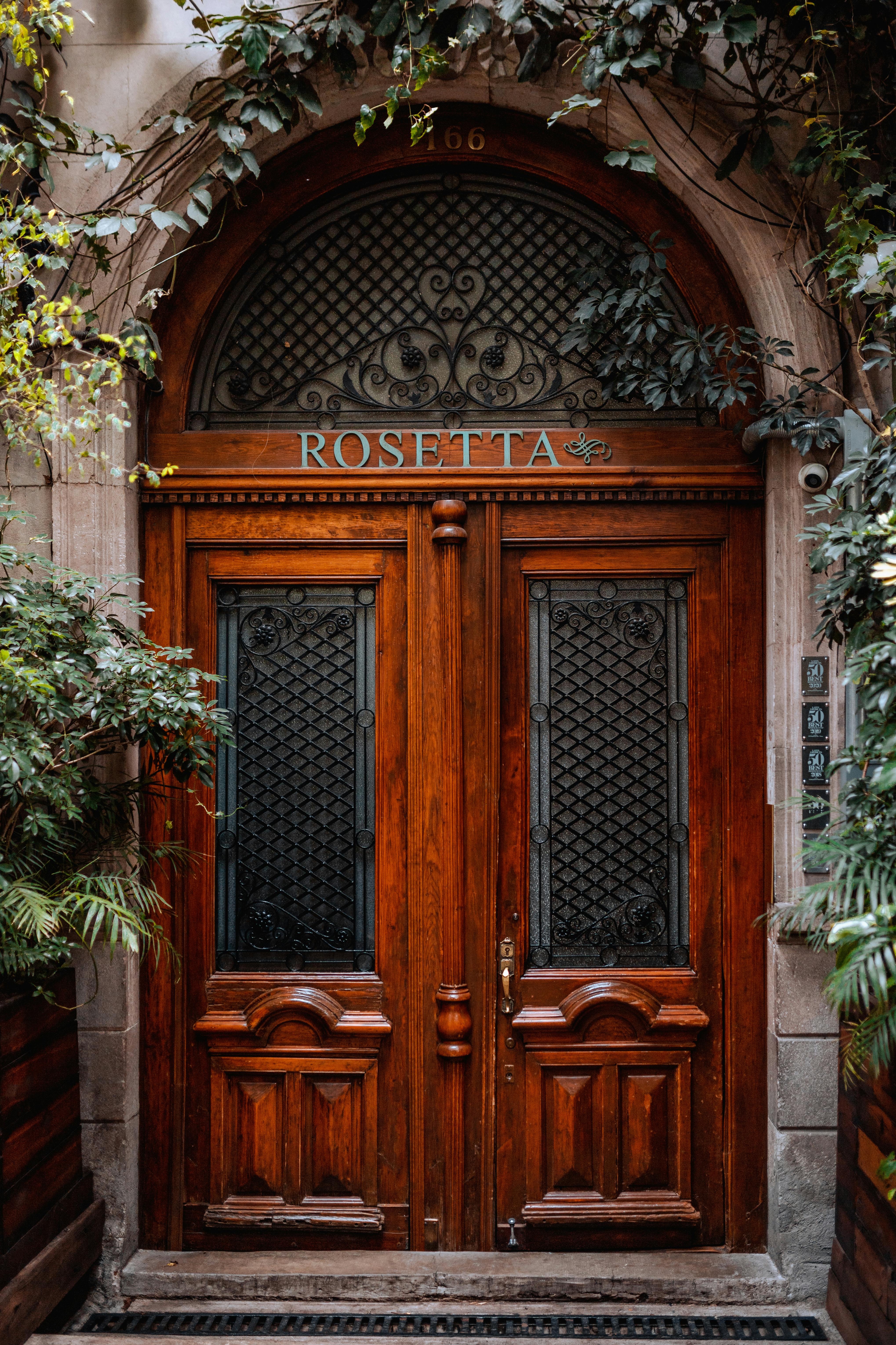 Elegant wooden entrance of Rosetta restaurant in Mexico City, showcasing rich architectural details.