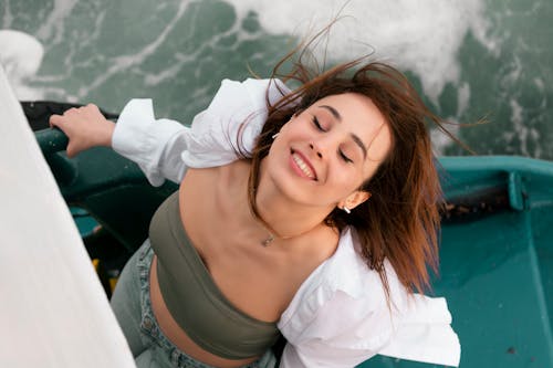 Woman Posing with Eyes Closed on Boat