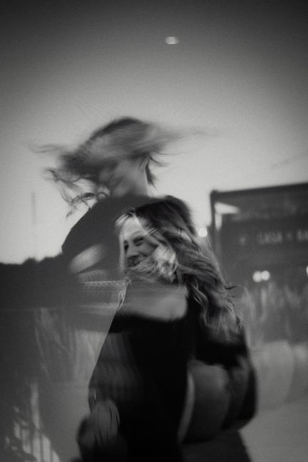Creative black and white portrait of a woman dancing with blurred motion.