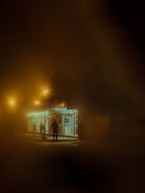 Foggy urban night street scene in Oaxaca de Juárez, creating a mysterious atmosphere.