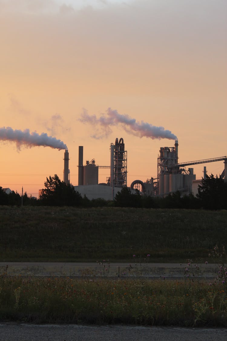 Smoke From Factory Chimneys At Sunset