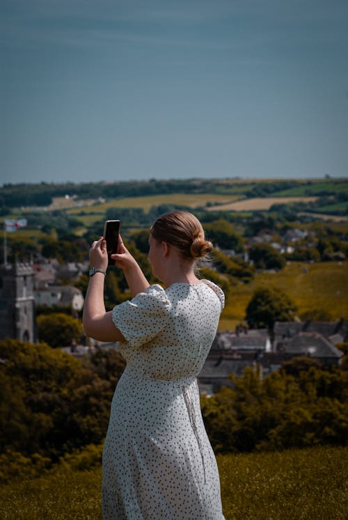 Woman with Smartphone on Hill