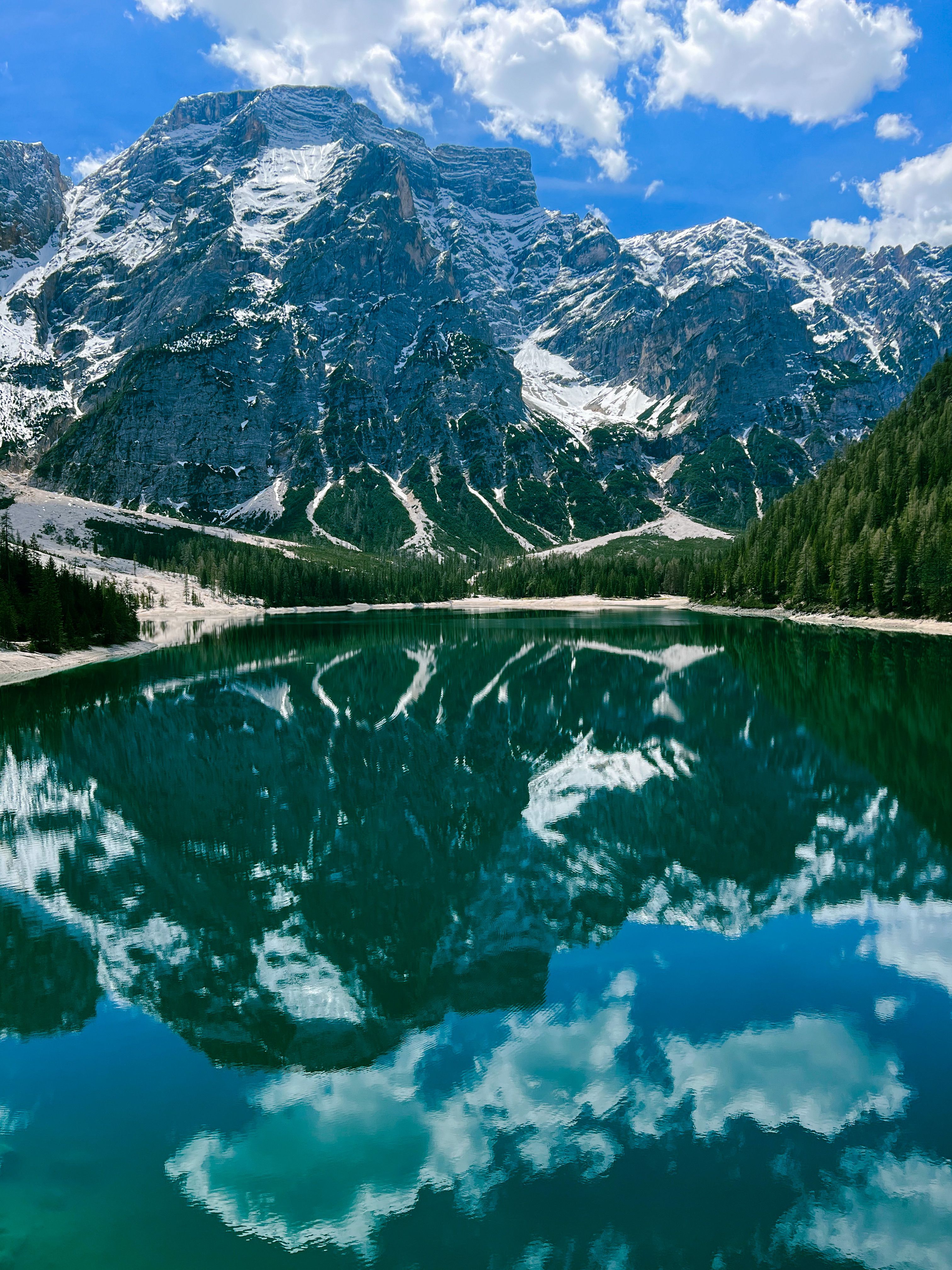 Brown and Gray Mountains Near Lake Under Cloudy Sky · Free Stock Photo