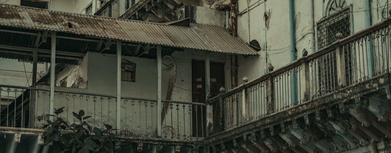 A decaying urban building facade showcasing architectural neglect and heritage decay in India.