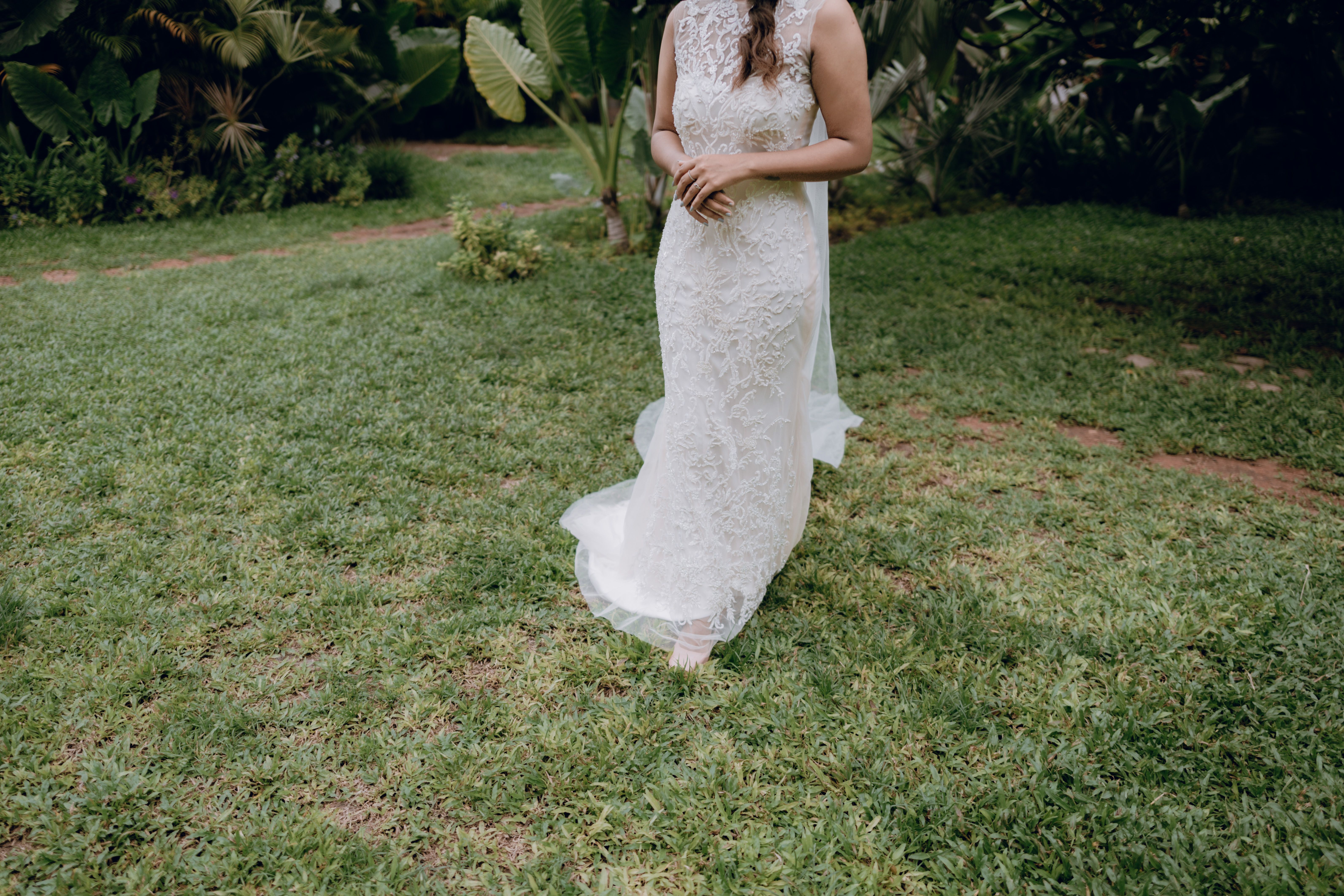 Woman in White Lace Wedding Dress Standing on a Lawn  Free Stock Photo