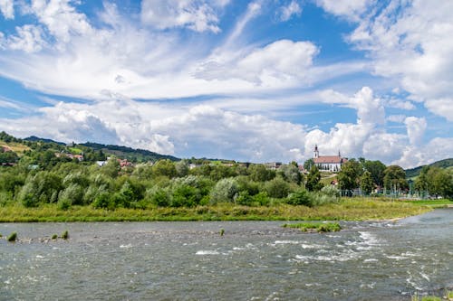 Cascading Body of Water Under Sky With Clouds