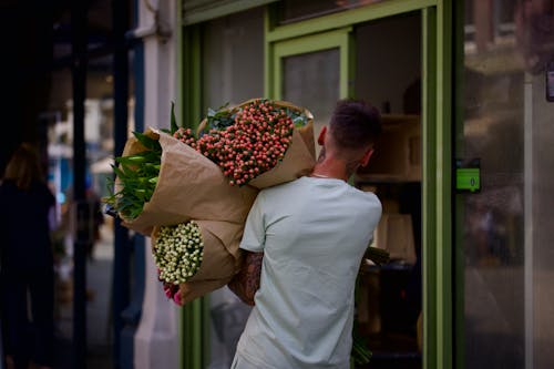 Man Carrying Flowers Bouquets