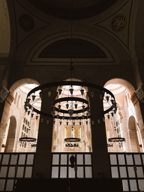Free Stunning interior of an Ottoman mosque featuring intricate arches and chandeliers, showcasing Islamic architecture. Stock Photo