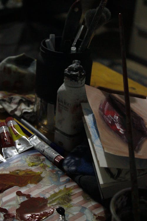 Close-up of a Messy Desk with Art Supplies 