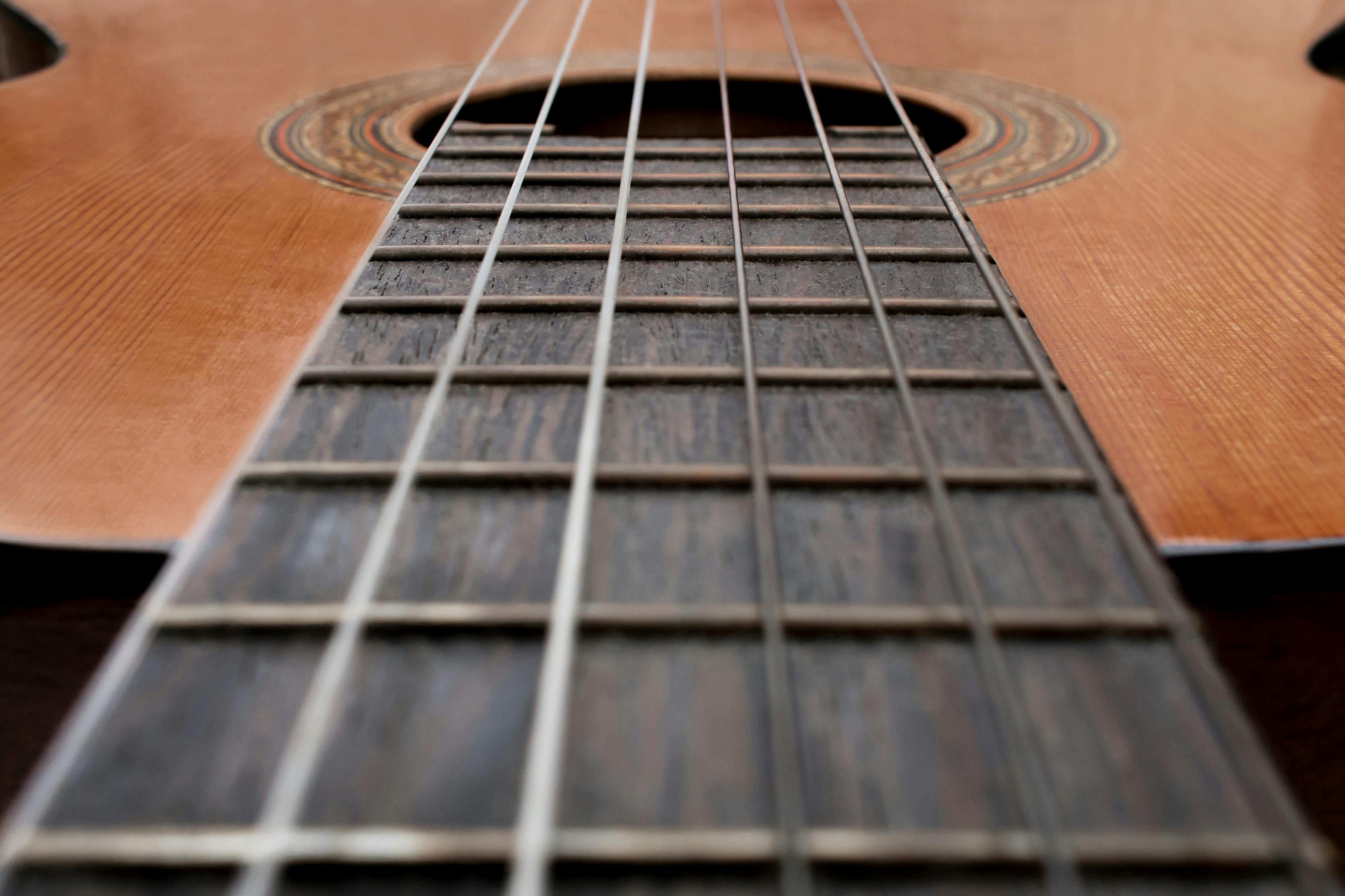 Close up of old acoustic guitar fretboard with selective focus in