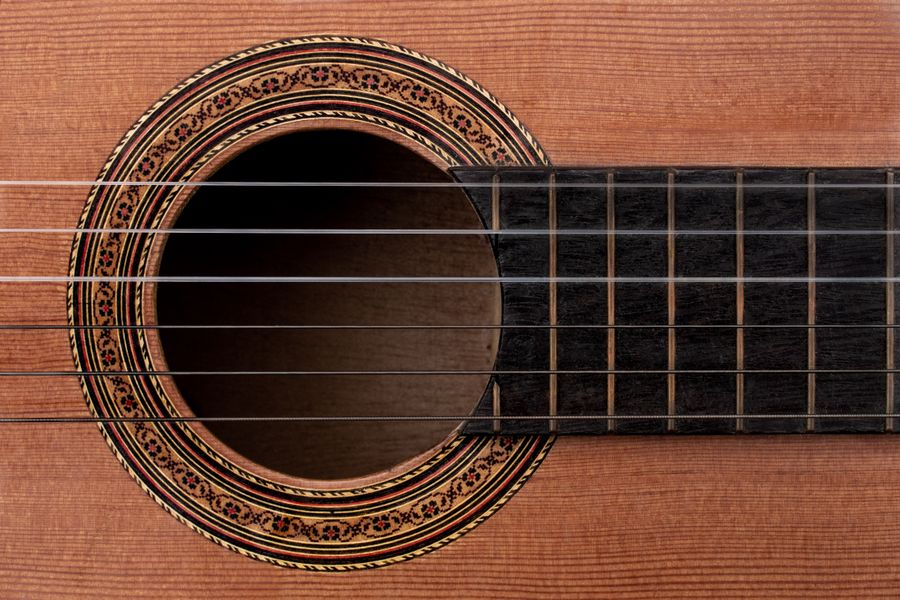 An old acoustic guitar rosette and soundhole in detail