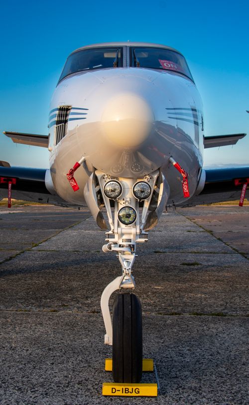 Free Close-up frontal shot of a private jet, showcasing aircraft nose and landing gear. Stock Photo