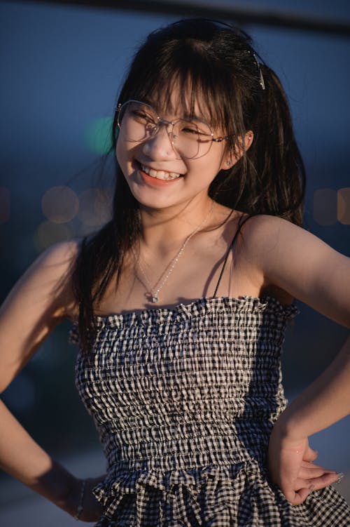 Young Brunette with Bangs Wearing a Dress and a Eyeglasses