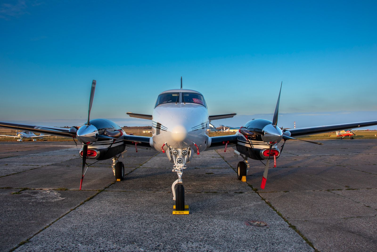 A twin-engine light aircraft on the tarmac