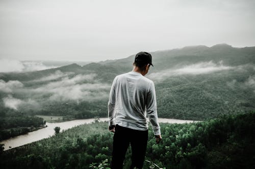 Free Photo of Man Standing at the Edge of a Cliff Stock Photo
