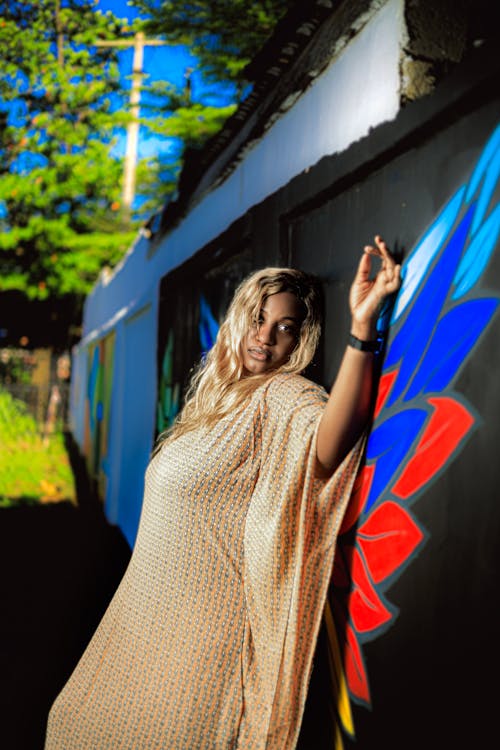 Woman in Dress Posing by Wall with Graffiti