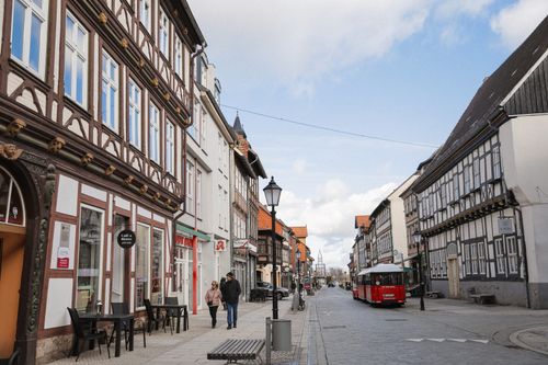 Free A picturesque street with half-timbered buildings and pedestrians in a German town. Stock Photo