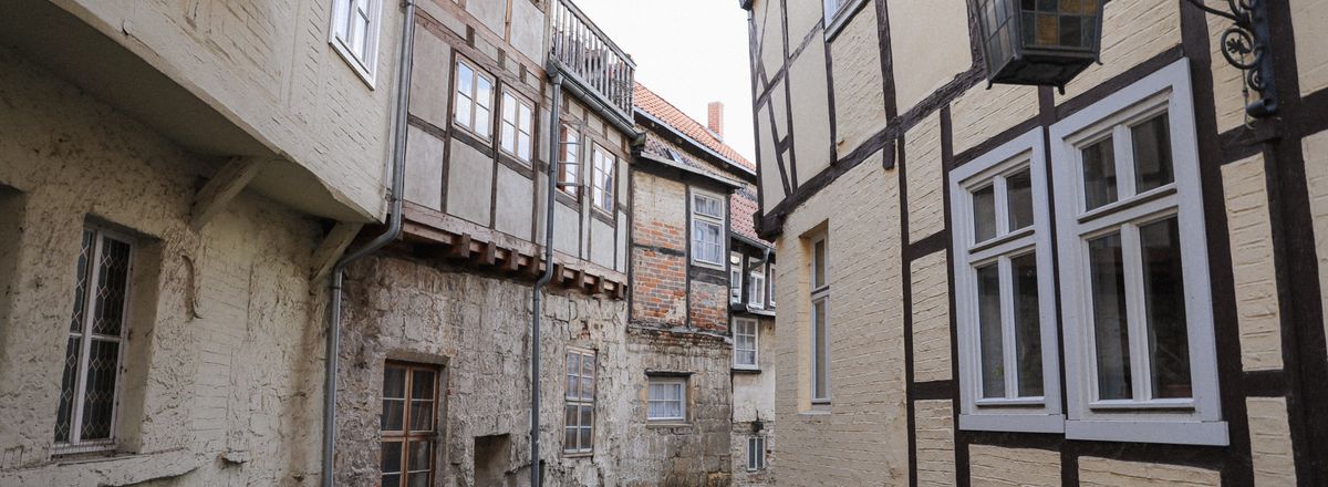 Historic alley in Quedlinburg with UNESCO World Heritage half-timbered buildings and classic lantern.