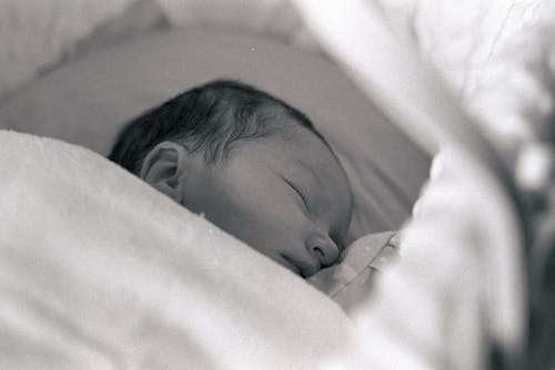 Newborn on Baby Bed