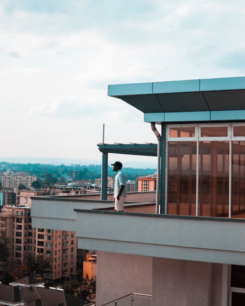 Free Man Standing on Balcony Stock Photo