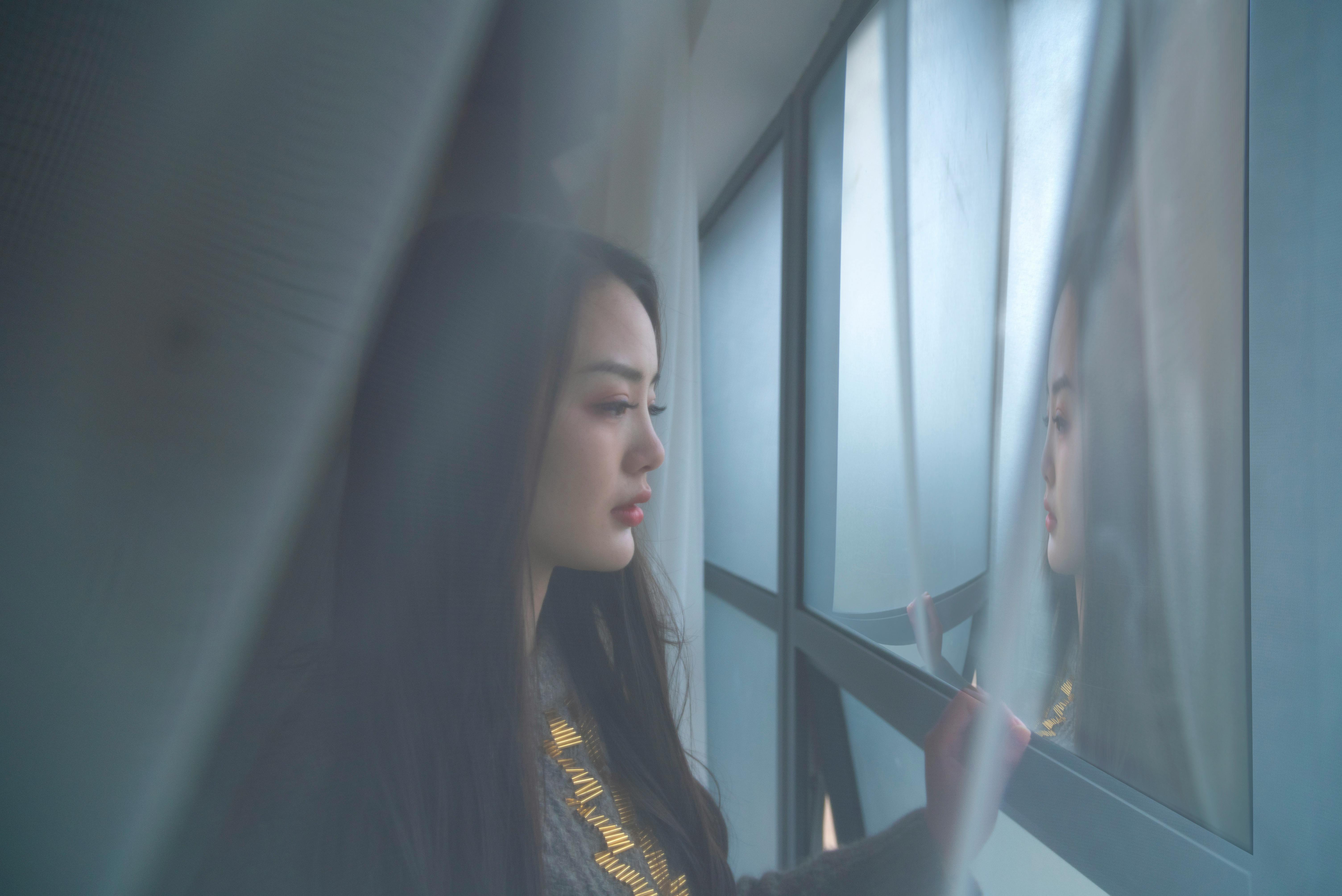 thoughtful person looking out a window - what is discernment counseling