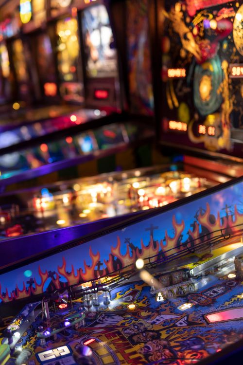 Free Colorful pinball machines in a lively arcade, capturing nightlife vibes. Stock Photo