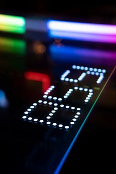 Close-up of a colorful arcade machine display with points and reflections.