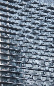 Close-up of a contemporary apartment building facade in New York featuring extensive glass balconies.