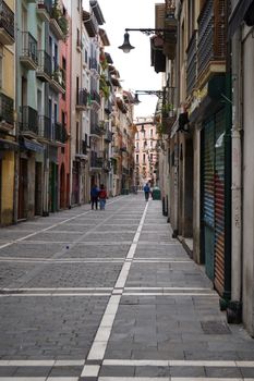 Discover the quaint urban charm of an alley in Pamplona, perfect for travel enthusiasts.
