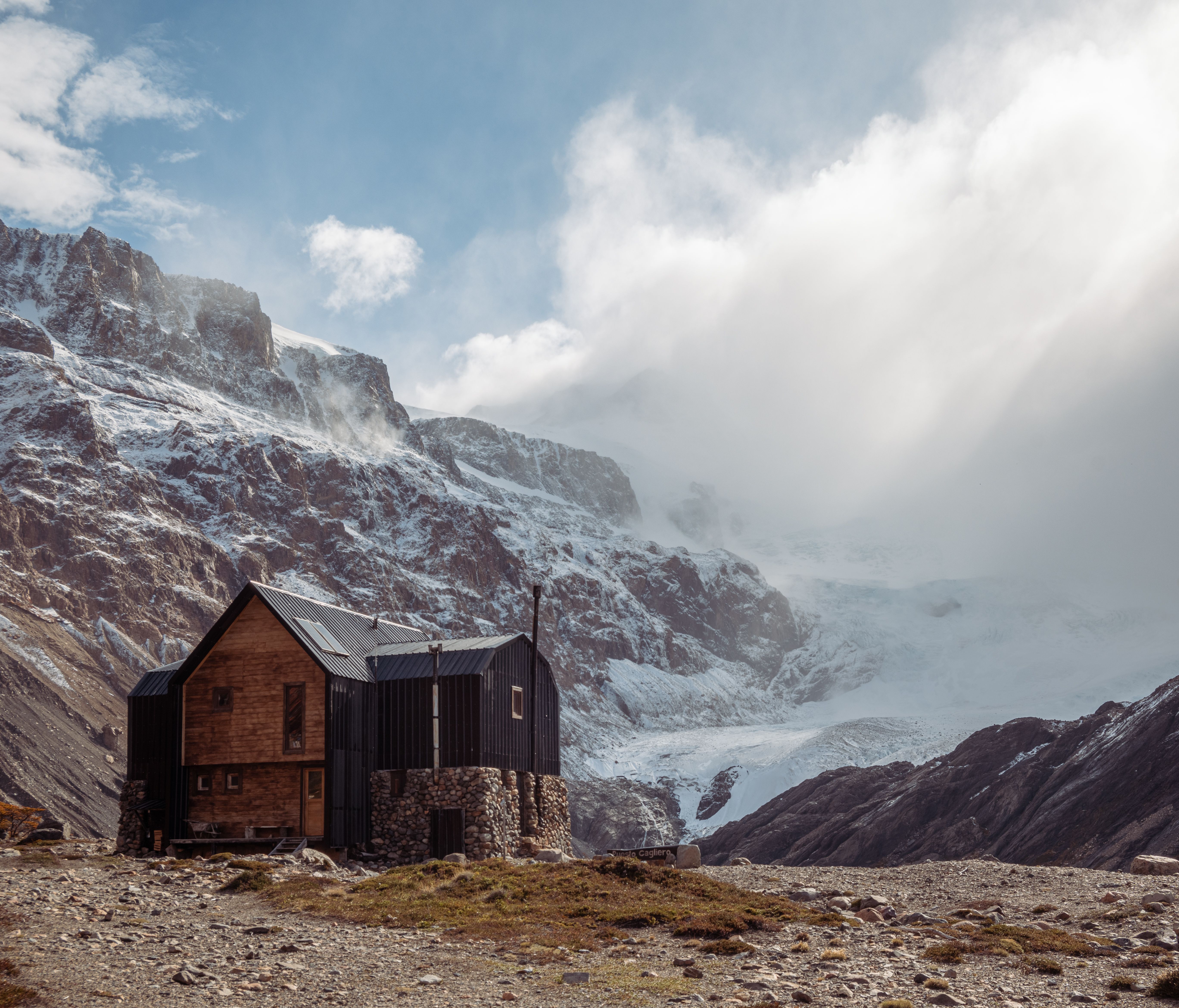 Scenic view of a cabin near snowcapped mountains in El Chalten, Argentina.