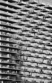 Black and white photo of a modern New York apartment building with balconies.