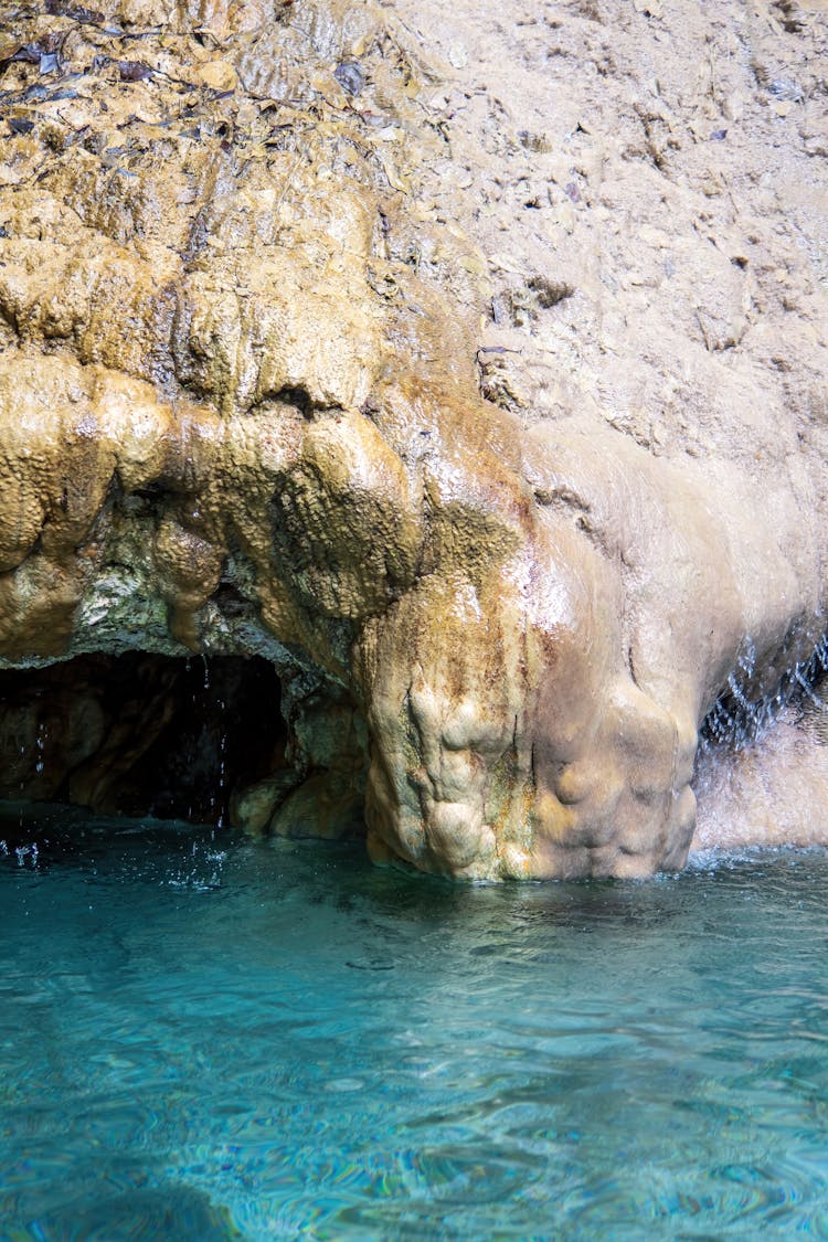 Spring Water Flowing On Rock