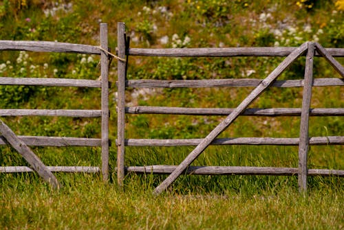 A Wooden Fence on a Meadow in the Countryside 