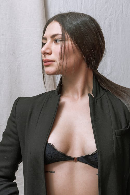 Woman in Unzipped Suit Jacket and Bra