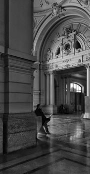 Black and white photo of an ornate interior with a man sitting, in Santiago, Chile.