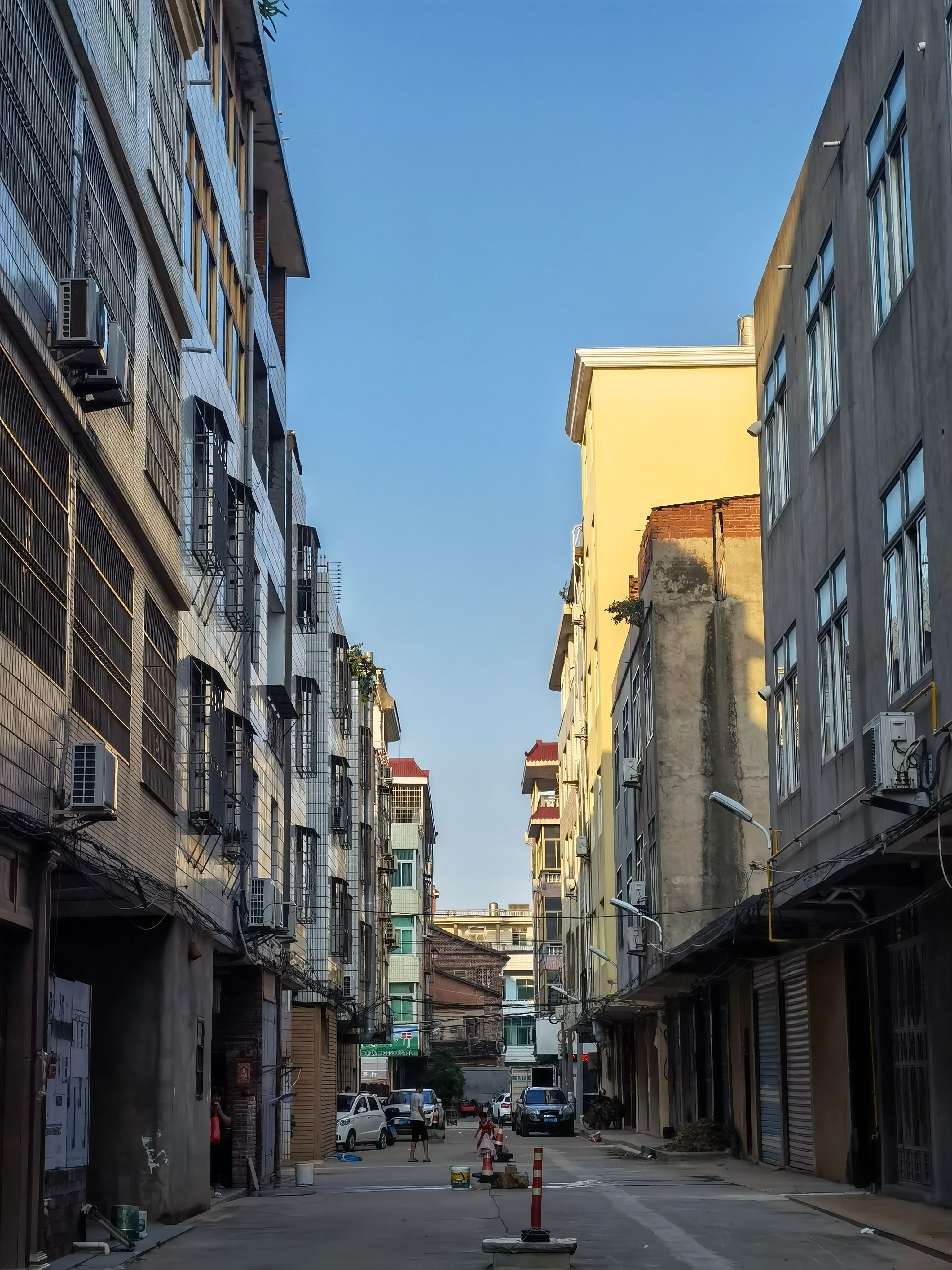 Narrow Street between Apartment Buildings in City · Free Stock Photo