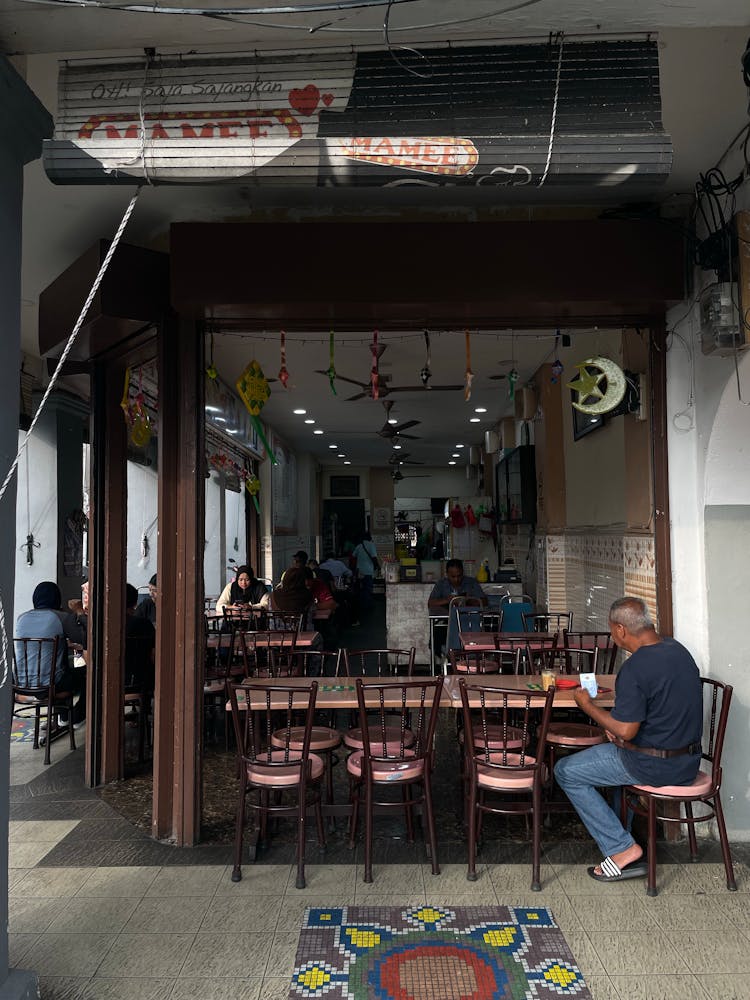 People Sitting And Eating In Food Bar