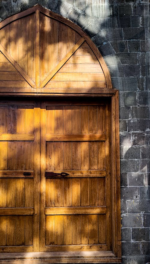 View of Old Wooden Door in a Brick Wall 