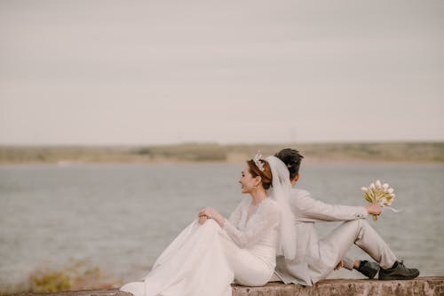 Newlyweds Sitting Together by Water