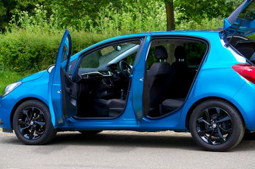 A Modern Blue Opel Corsa with Open Door and Trunk 