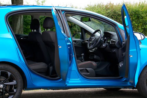 A Modern Blue Opel Corsa with Open Door